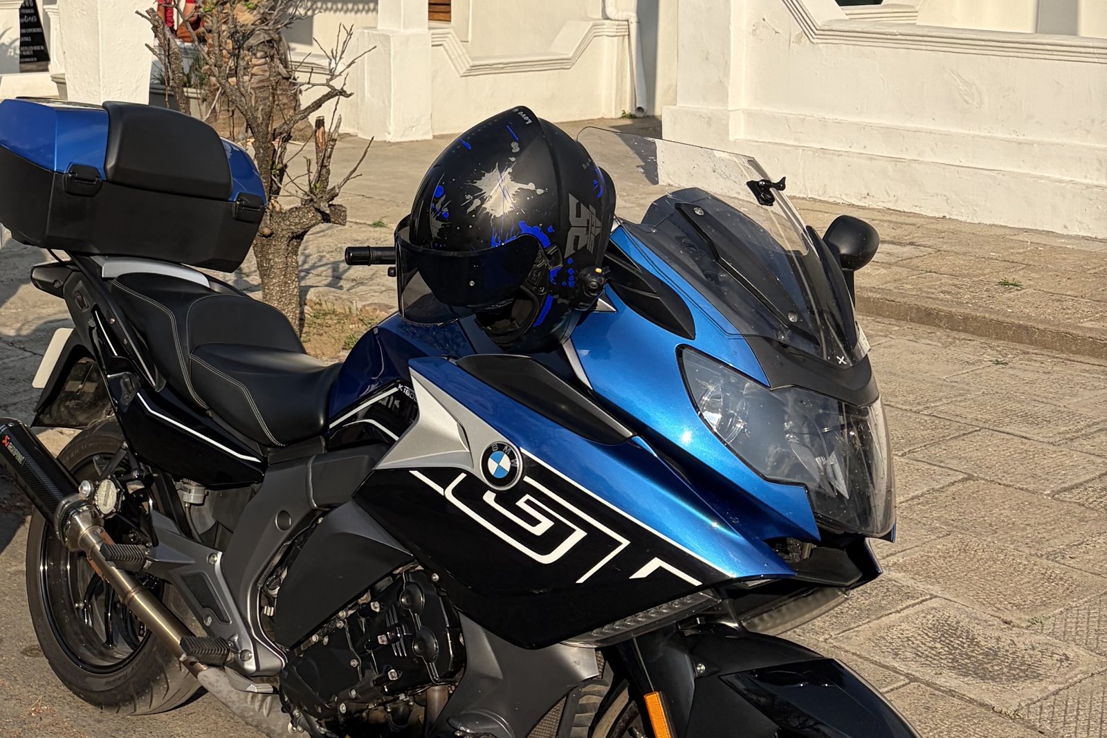Close view of a blue BMW K1600 GT parked beside the whitewashed Cape Dutch buildings of Graaff-Reinet.